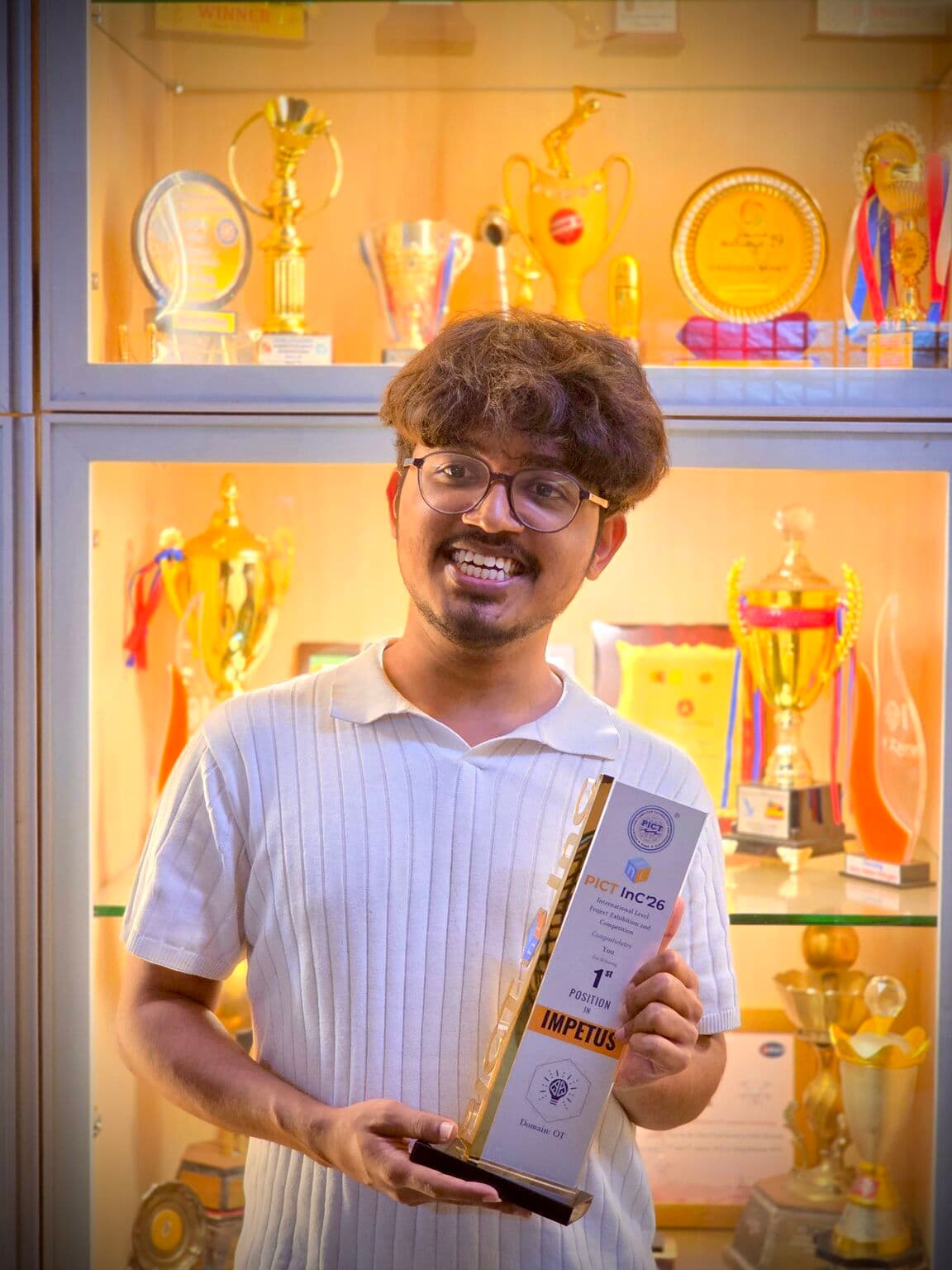 Abhijeet Bhosale holding the PICT InC 1st place trophy